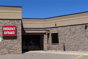 Emergency entrance of the brick Munising Memorial Healthcare Facility