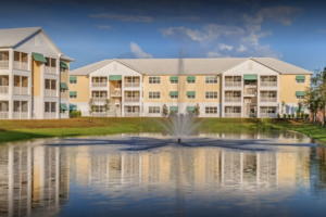 Screen Shot 2021-11-23 at 7.54.10 PM Apartment buildings reflected in a pond with a fountain
