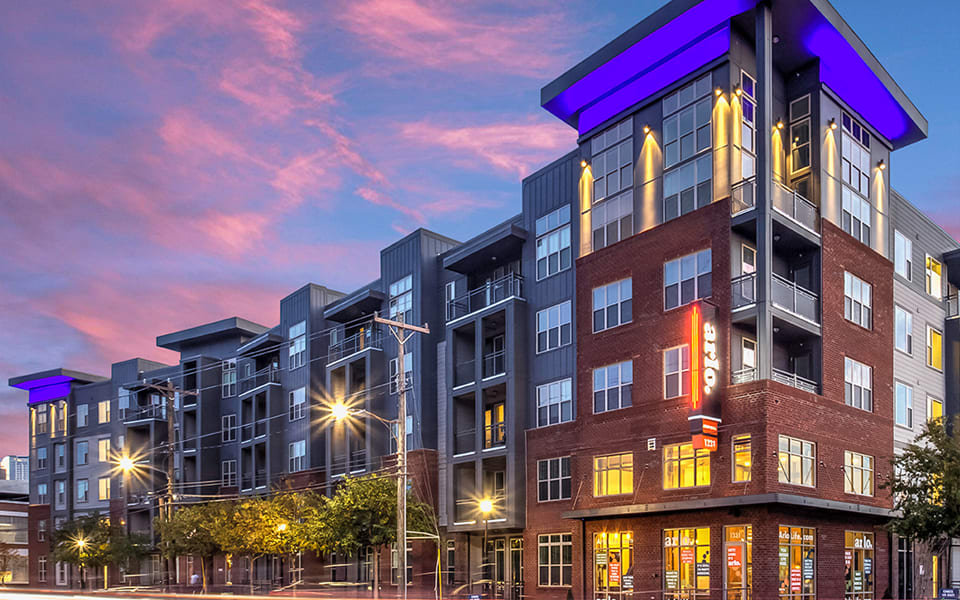 Gray Company apartment building lit at dusk