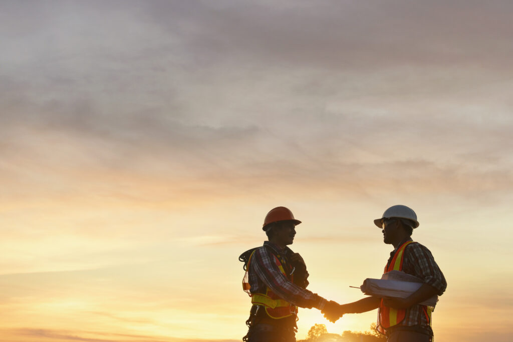 Construction Consultant Shakes Hands With Client to Confirm Construction Monitoring