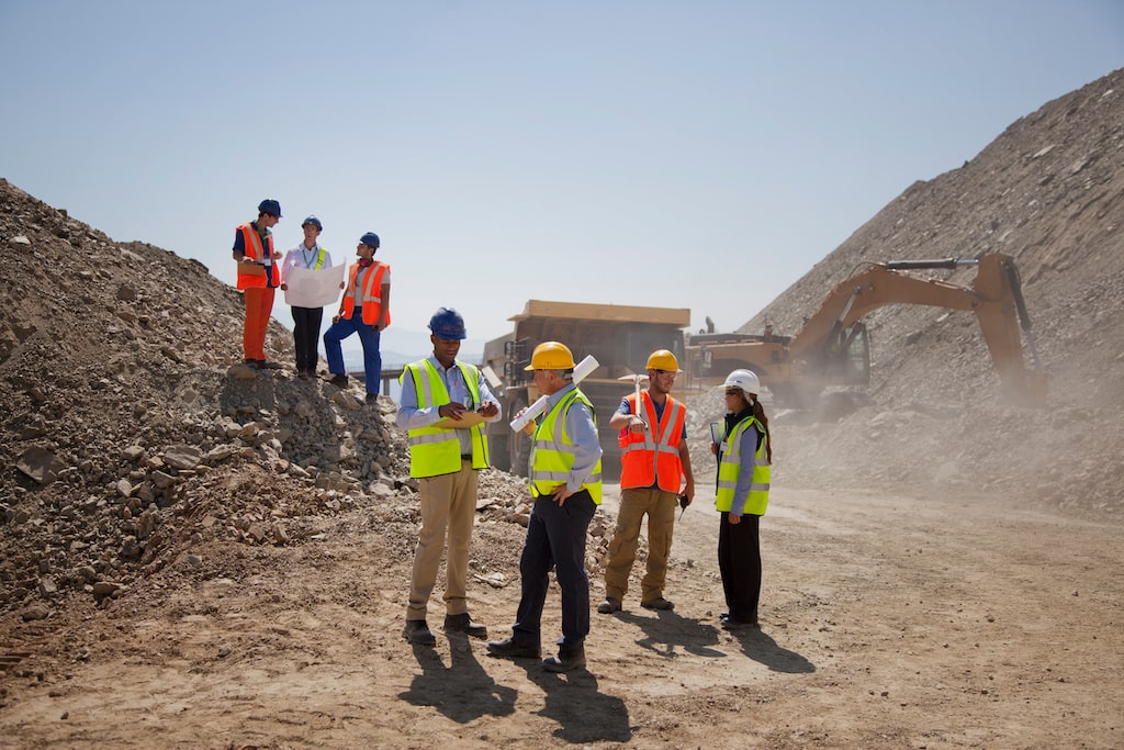 multi_family_construction_monitoring_4 Construction workers on site discussing the results of their multi-family construction monitoring.