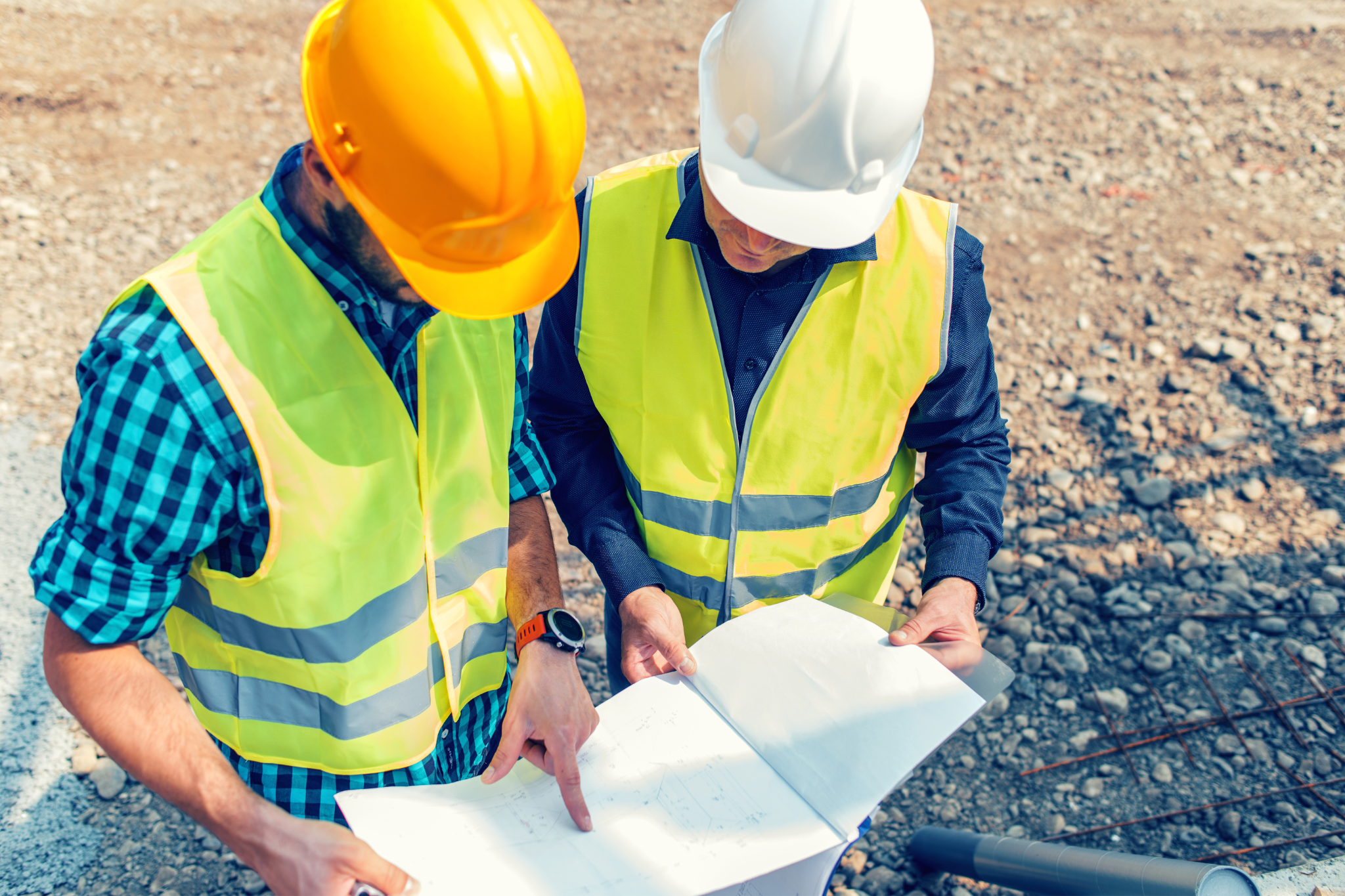 zumBrunnen_school_property_condition_assessment Two zumBrunnen construction workers discussing the report from a school property condition assessment.