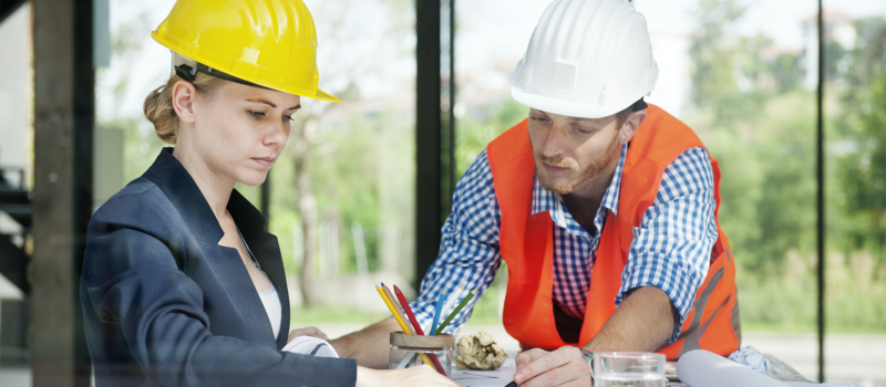 Construction professionals reviewing blueprints for life safety systems in senior living construction – zumBrunnen