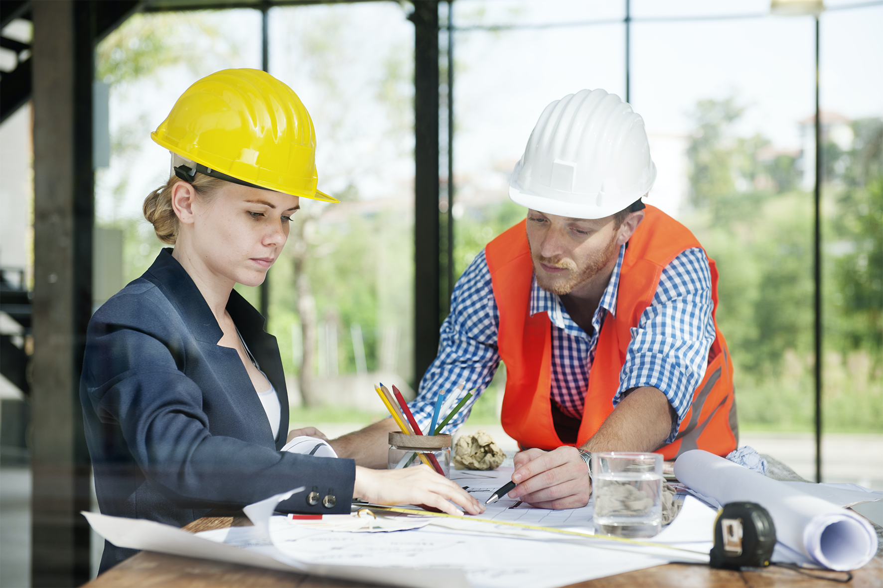 Construction professionals reviewing blueprints for life safety systems in senior living construction – zumBrunnen