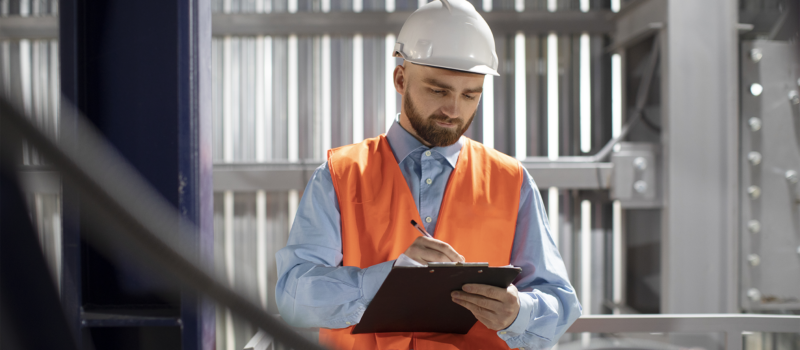 Engineer performing property condition assessment with checklist at senior living facility – zumBrunnen construction consulting
